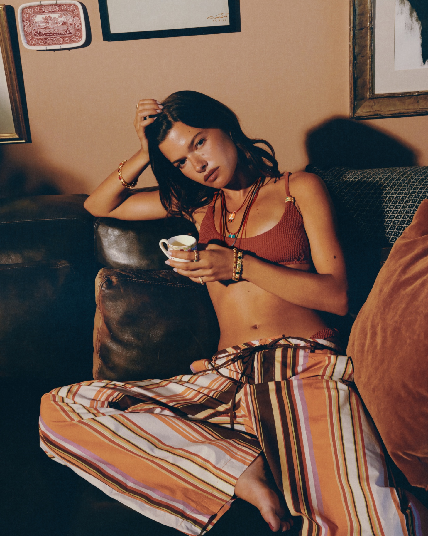 Woman on a leather sofa with tea